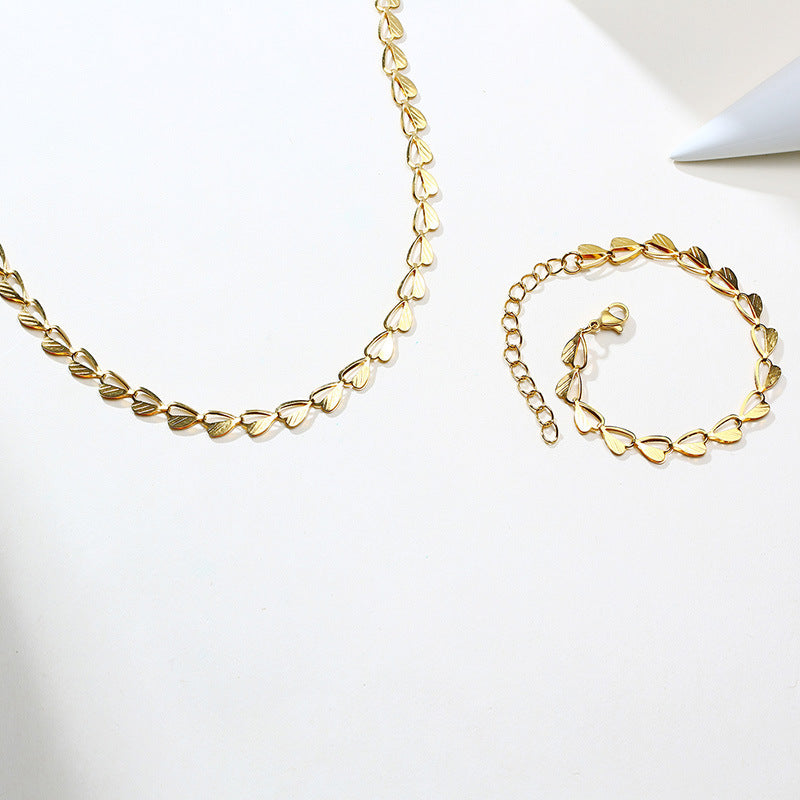 Armband med hjärta och löv i guld