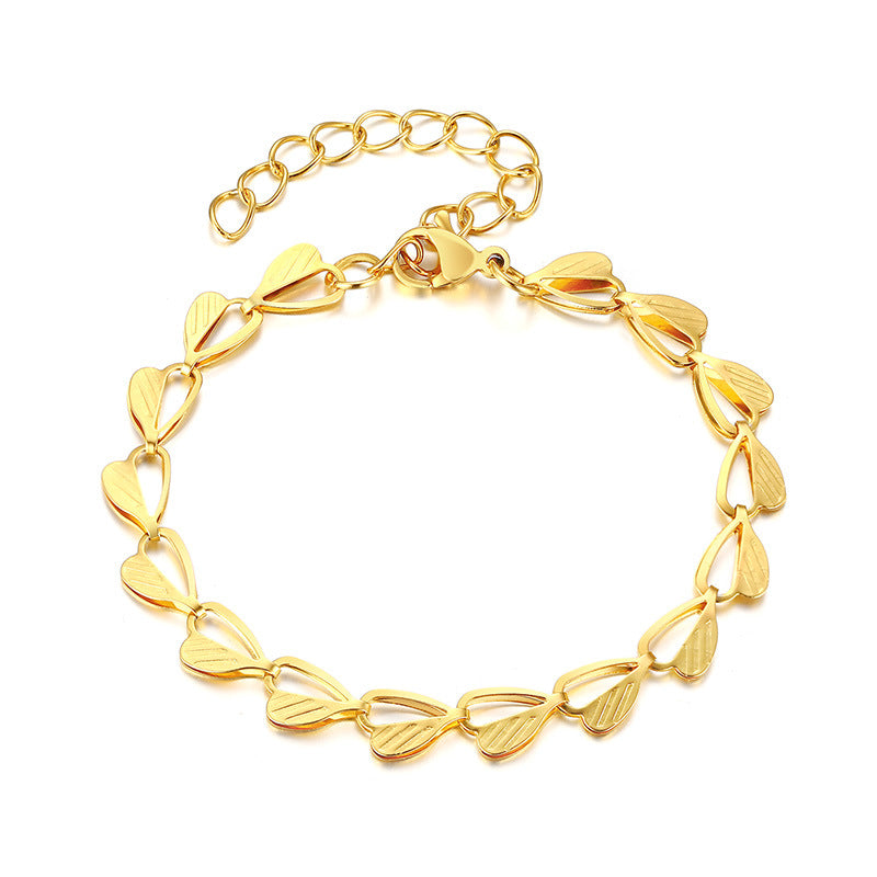 Armband med hjärta och löv i guld