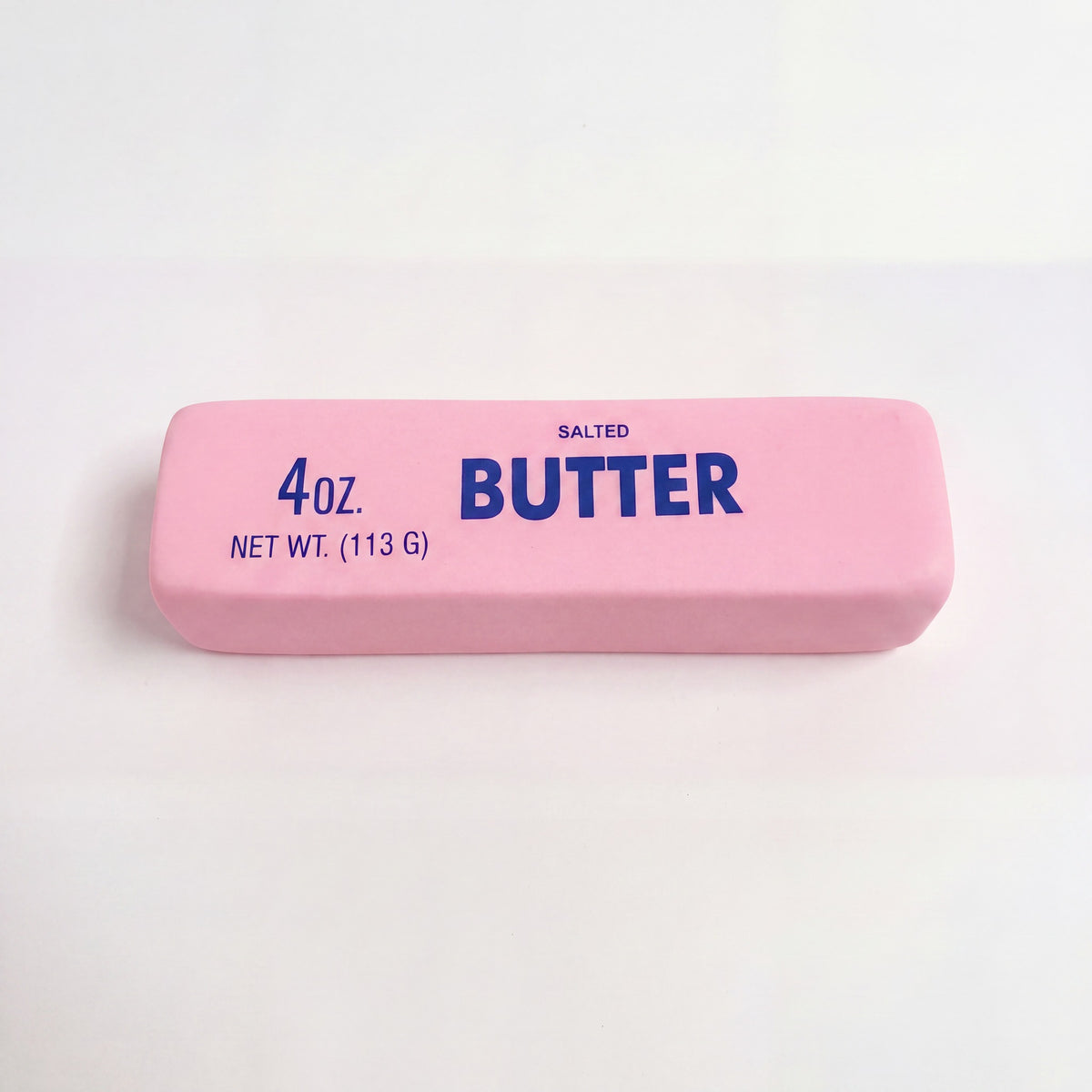 Stressleksak smorpaket rosa 4 oz salted butter pa neutral bakgrund